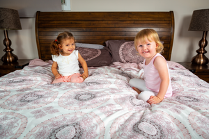 Organic-Natural-eco-friendly-cotton-sateen-quilt-cover-set-Diana-dusky-pink-king-size-two-little-girls-sitting-on-bed